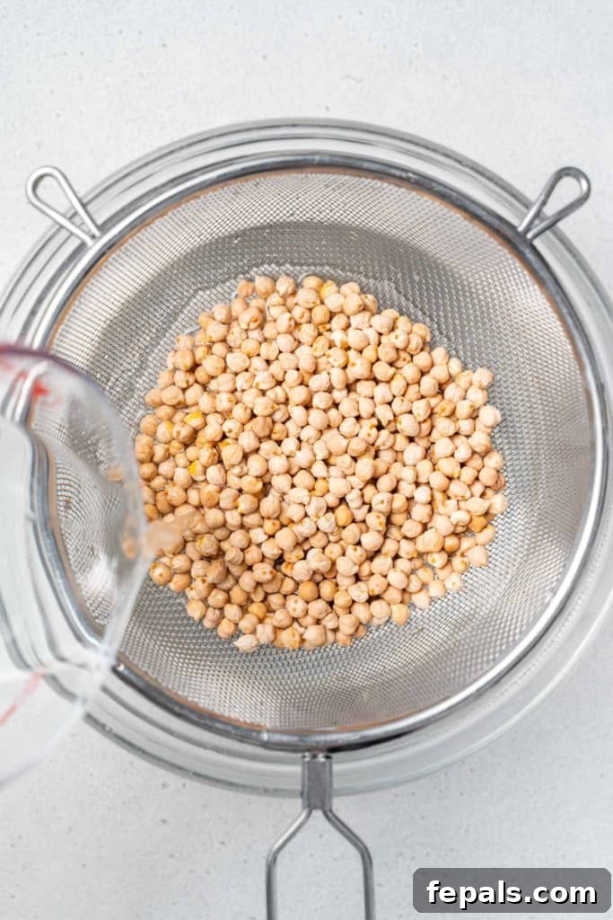 Your Guide to Perfectly Cooked Chickpeas 5 Rinsing chickpeas in a strainer.
