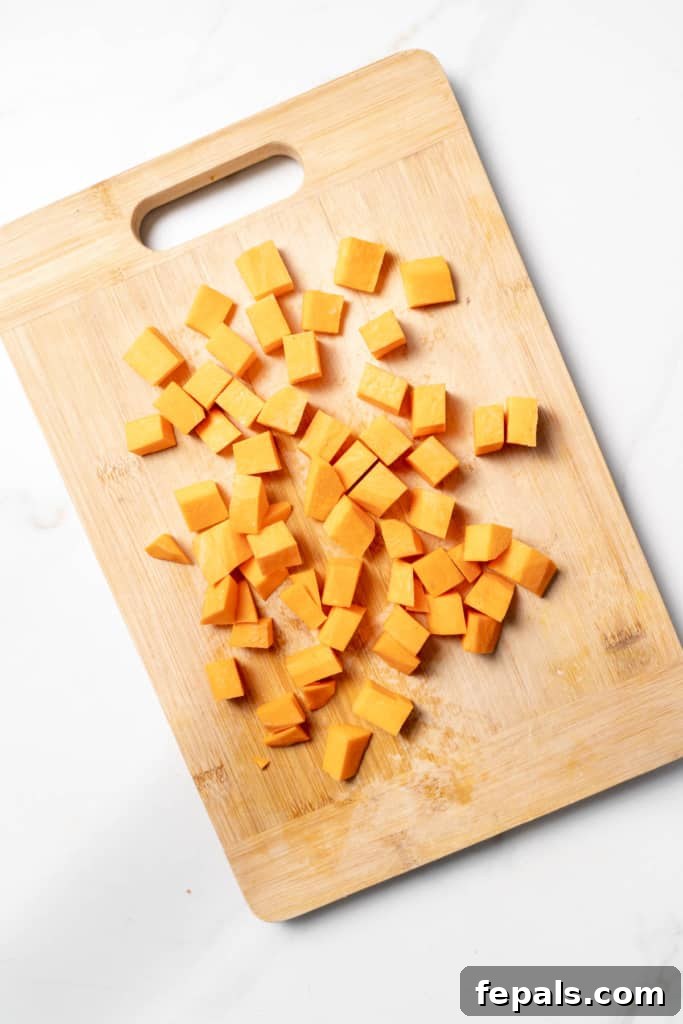Cubes of sweet potato on a cutting board.