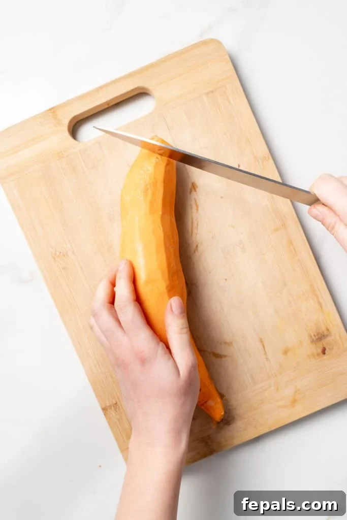 Slicing off the end of a sweet potato.