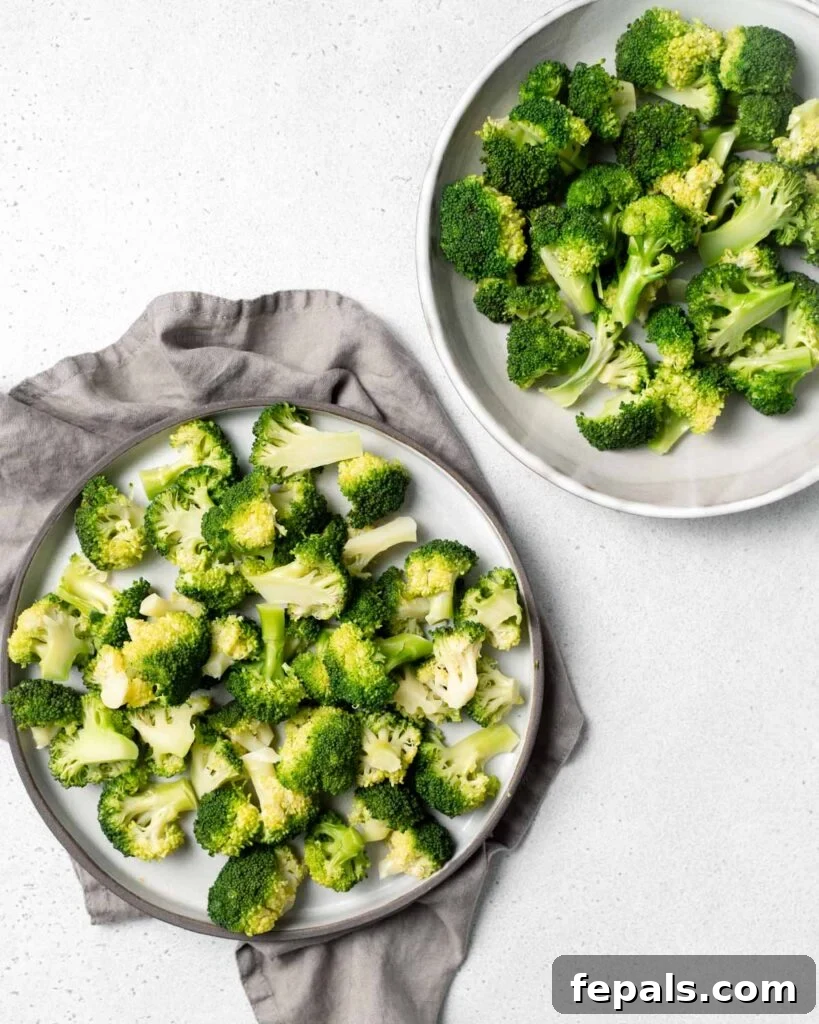 Stovetop Broccoli Perfection 17 A large serving plate full of bright green broccoli florets next to a matching bowl also filled with broccoli.