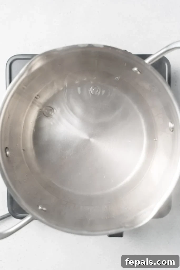 Stovetop Broccoli Perfection 9 Water rapidly boiling in a large pot on a gas stove.