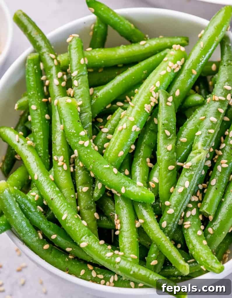 Garlic Sautéed Green Beans 3 Green beans in a white bowl.