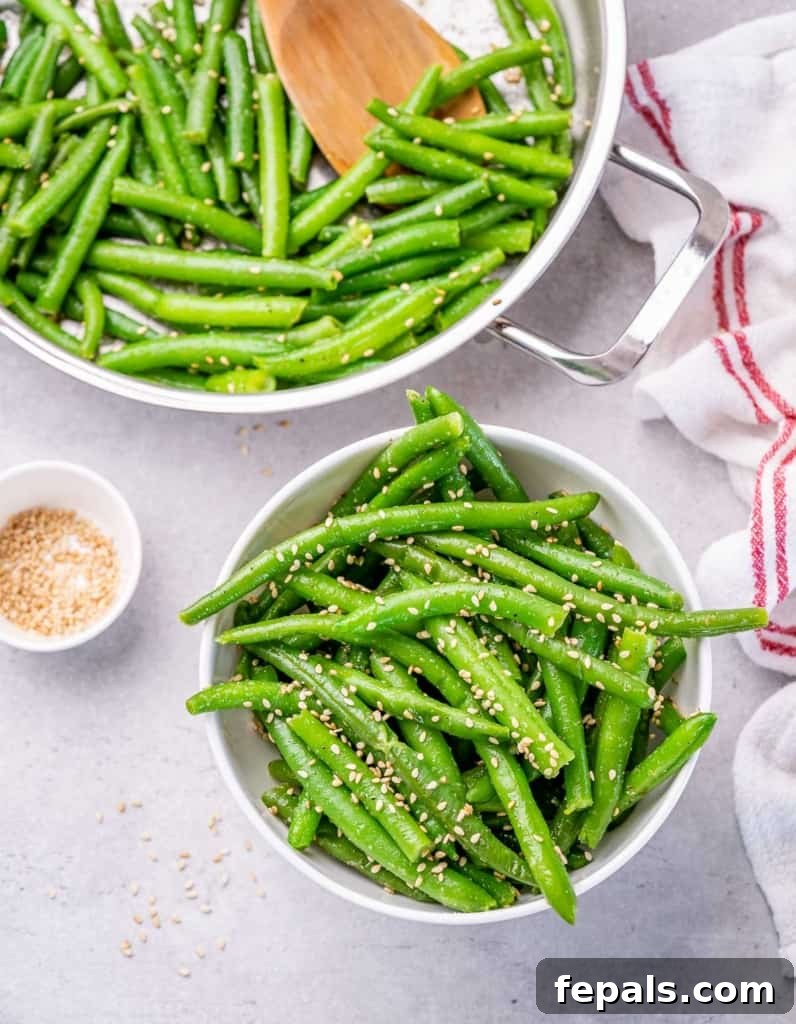 Garlic Sautéed Green Beans 8 top view green beans in a bowl with a skillet that has green beans as well on the upper left corner