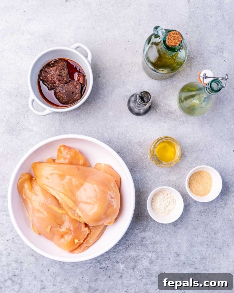 Crispy Honey Chipotle Chicken 4 Raw chicken, chipotle peppers in adobo and seasonings divided into small bowls.
