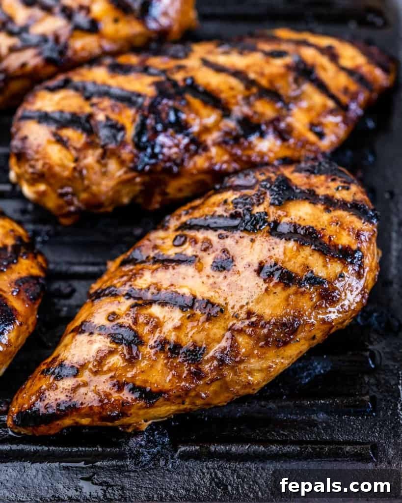 Crispy Honey Chipotle Chicken 7 Chicken breasts grilling with grill marks.