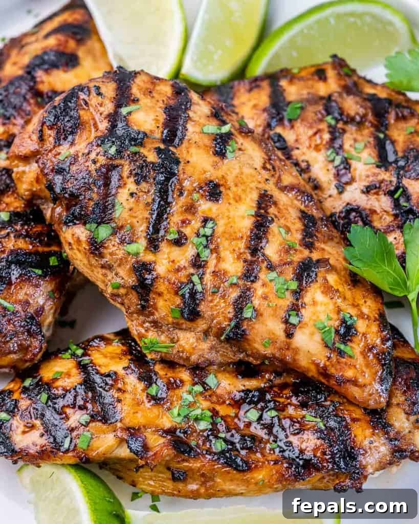 Crispy Honey Chipotle Chicken 9 Honey chipotle grilled chicken served with lime wedges on a white platter.