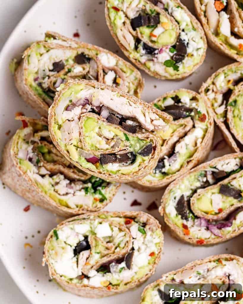 Top-down view of a plate filled with neatly arranged pinwheel bites, ready for serving.