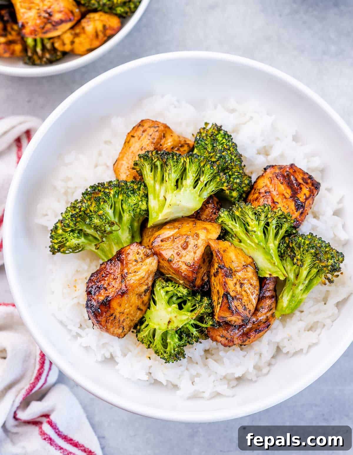 Top view of perfectly air-fried chicken chunks and vibrant broccoli served alongside fluffy white rice.
