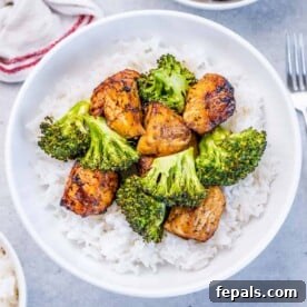 Top view of perfectly air-fried chicken chunks and vibrant broccoli served alongside fluffy white rice.