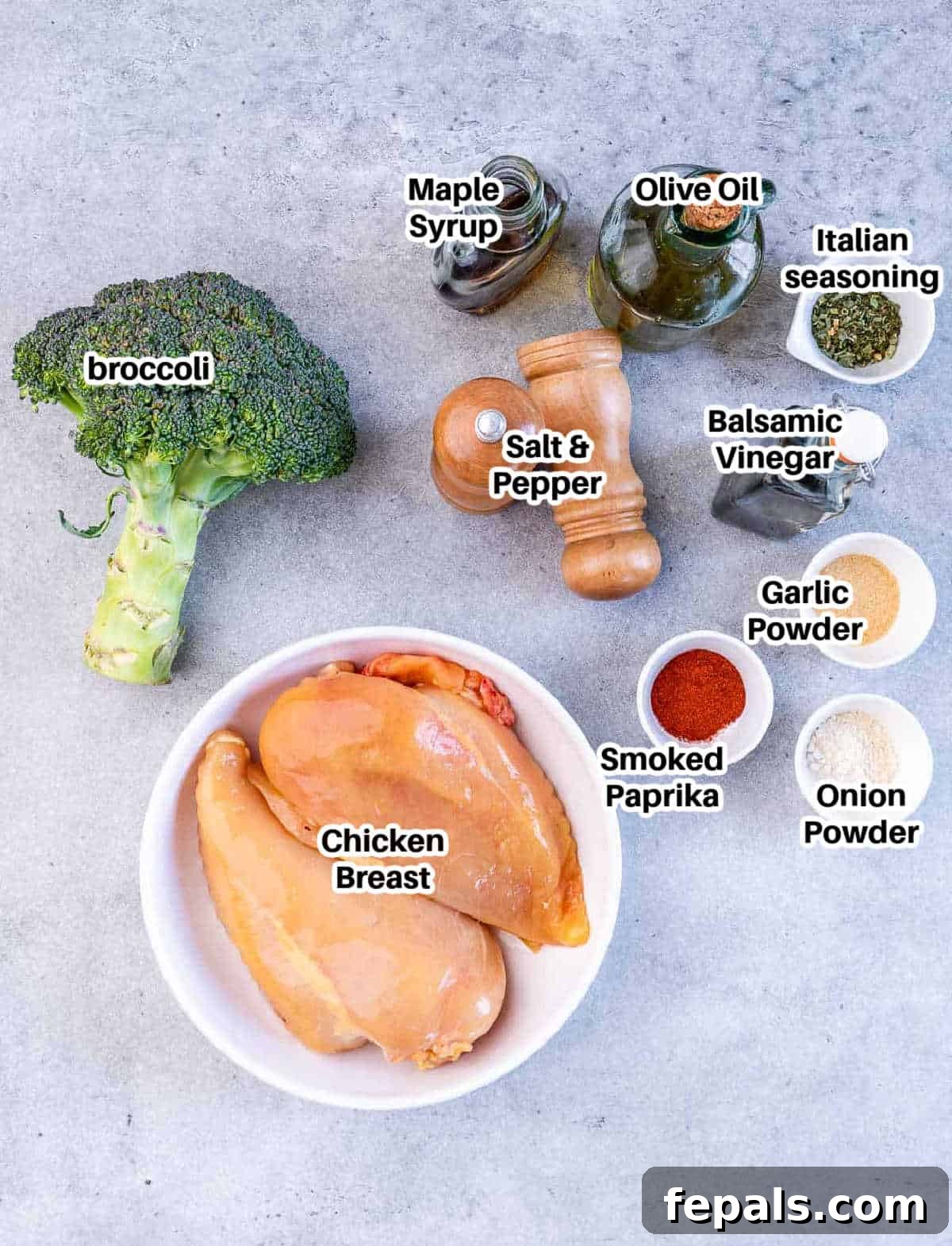 A visual display of fresh ingredients including chicken breast, broccoli, olive oil, and various spices, laid out for making air fryer chicken and broccoli with rice.