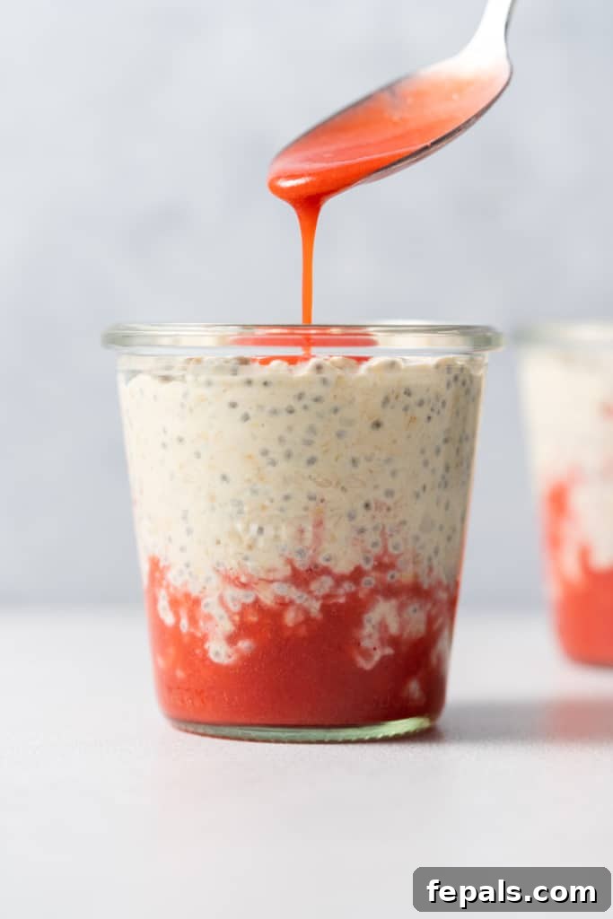 Pouring strawberry puree over oats.