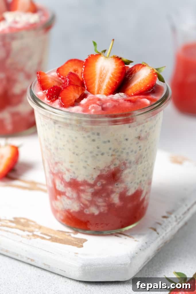 Strawberry and cream protein overnight oats served in a jar.
