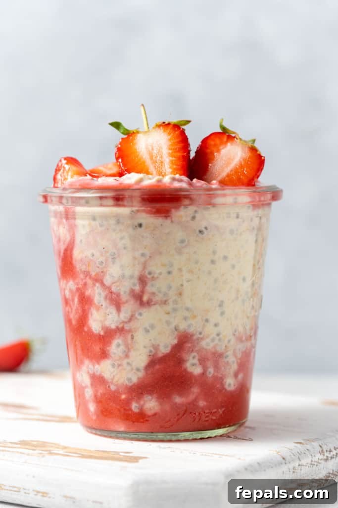 side shot of overnight oats with strawberries in a jar