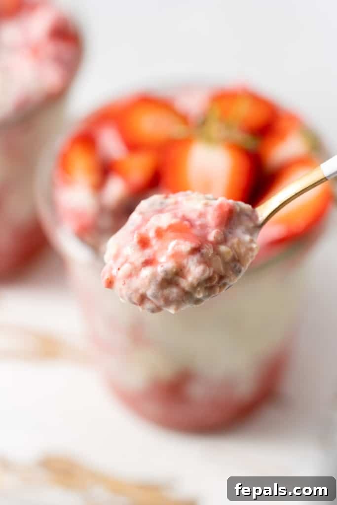 Spoonful of strawberry overnight oats.