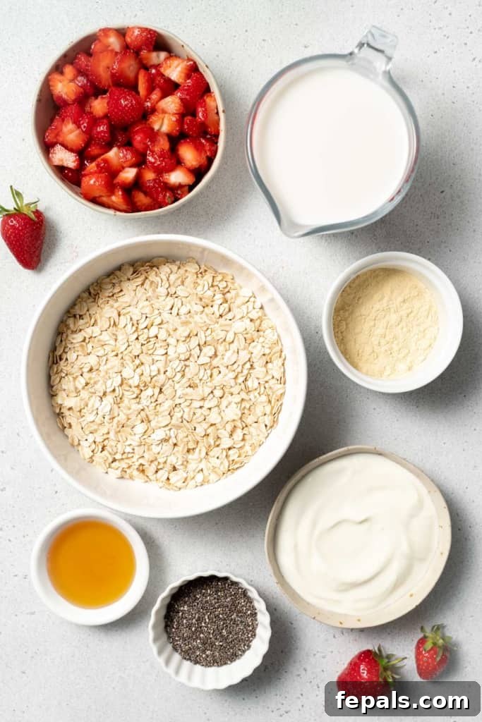 Oats, yogurt, chopped strawberries and honey divided into small bowls.