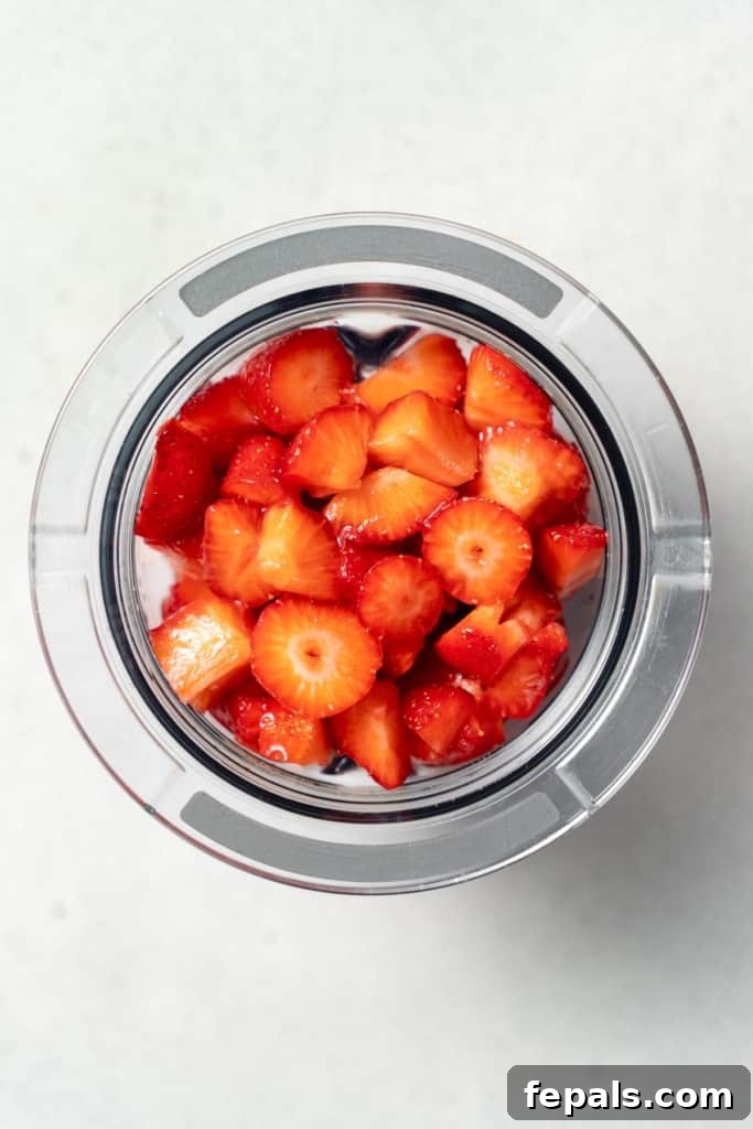 Chopped strawberries in a blender.