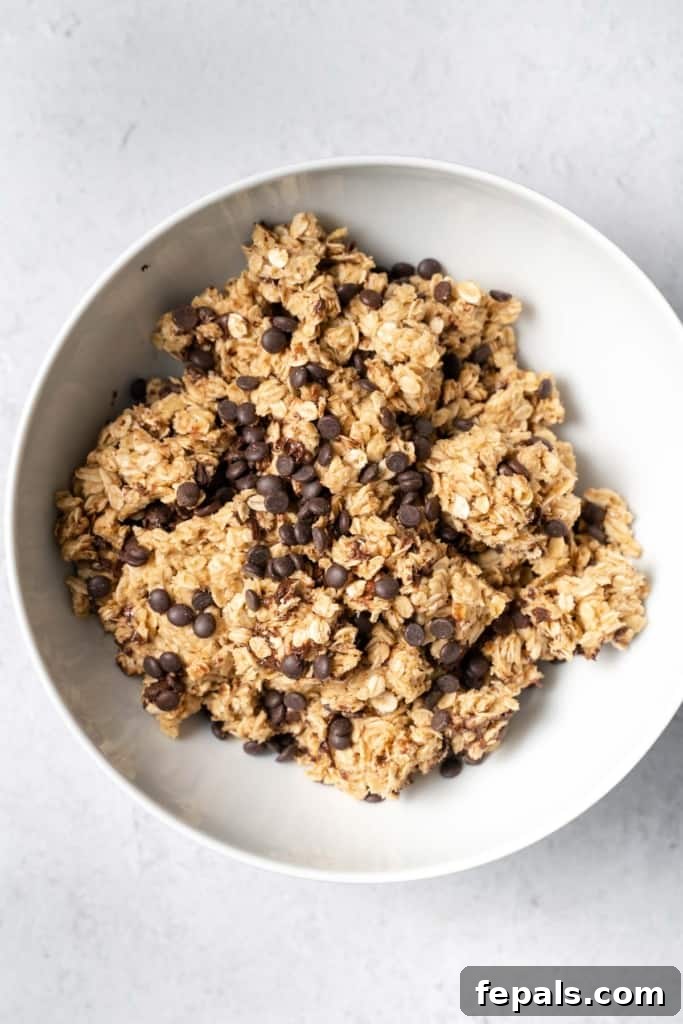 Chocolate chips mixed with oats, peanut butter, and honey, creating a rich and textured bar base.