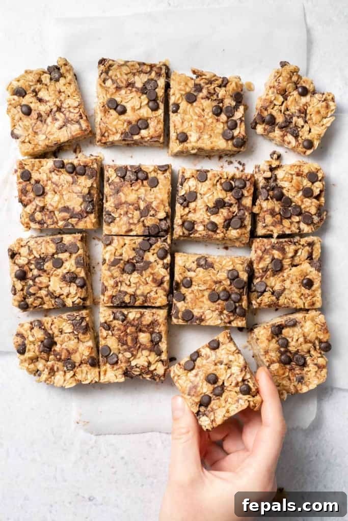 Hand taking an oatmeal bar from the others, ready to be enjoyed.