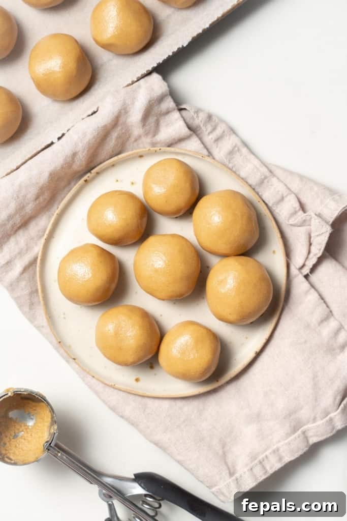 Top view of peanut butter balls on a round white plate.