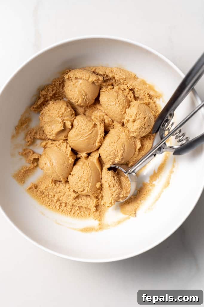 Using a cookie scoop to scoop balls of dough.