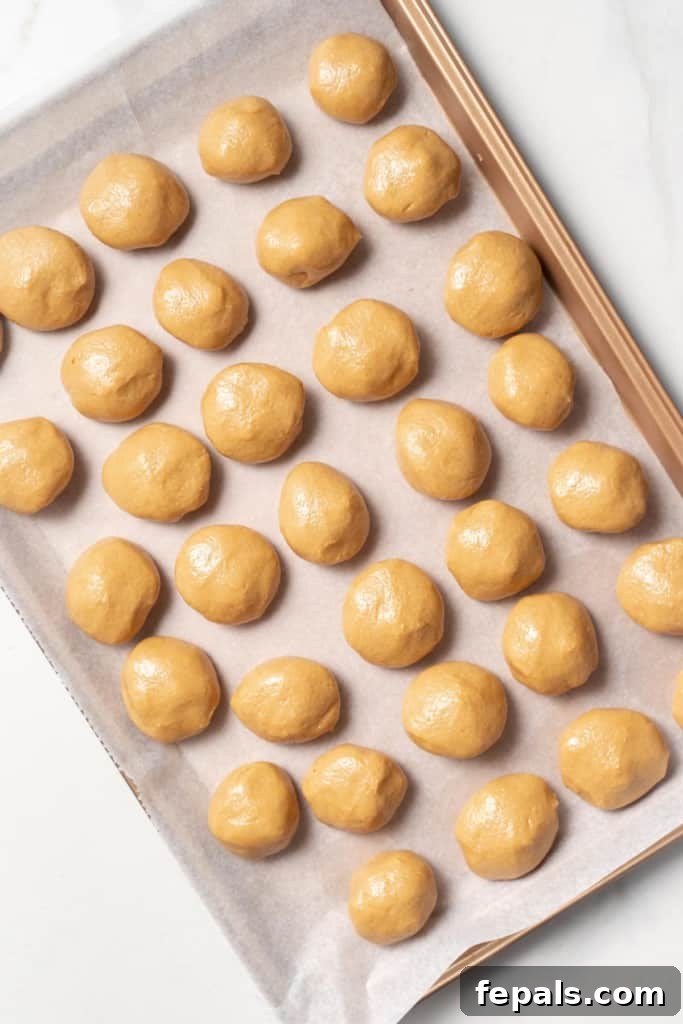 top view of peanut butter balls lined up on a pan