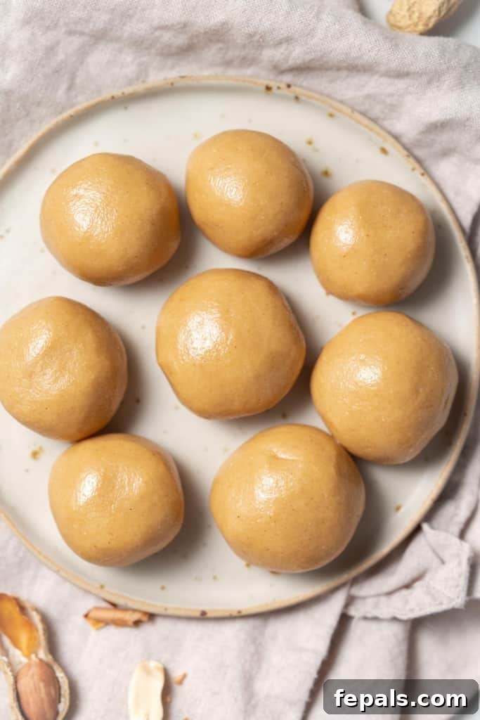 top view of 8 peanut butter balls on a round white plate 