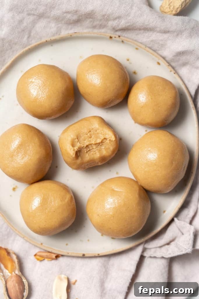 Energy bites on a white plate with a bite taken out of one.