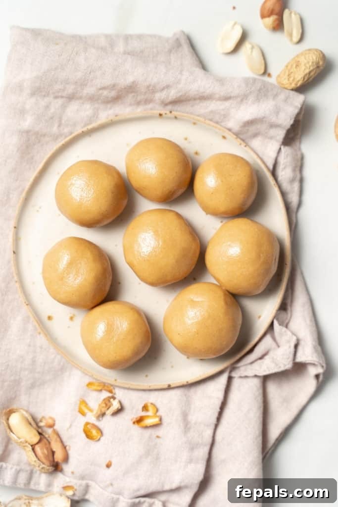 top view of a white plate that has 8 peanut butter balls