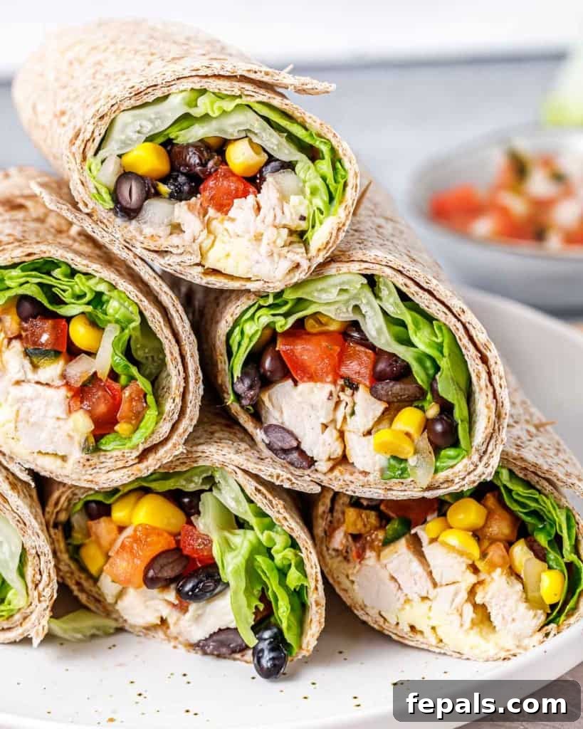 Spicy Southwest Chicken Wrap 2 Stacked Southwest Chicken Wraps on a plate, showcasing their inviting layers and golden-brown tortillas.