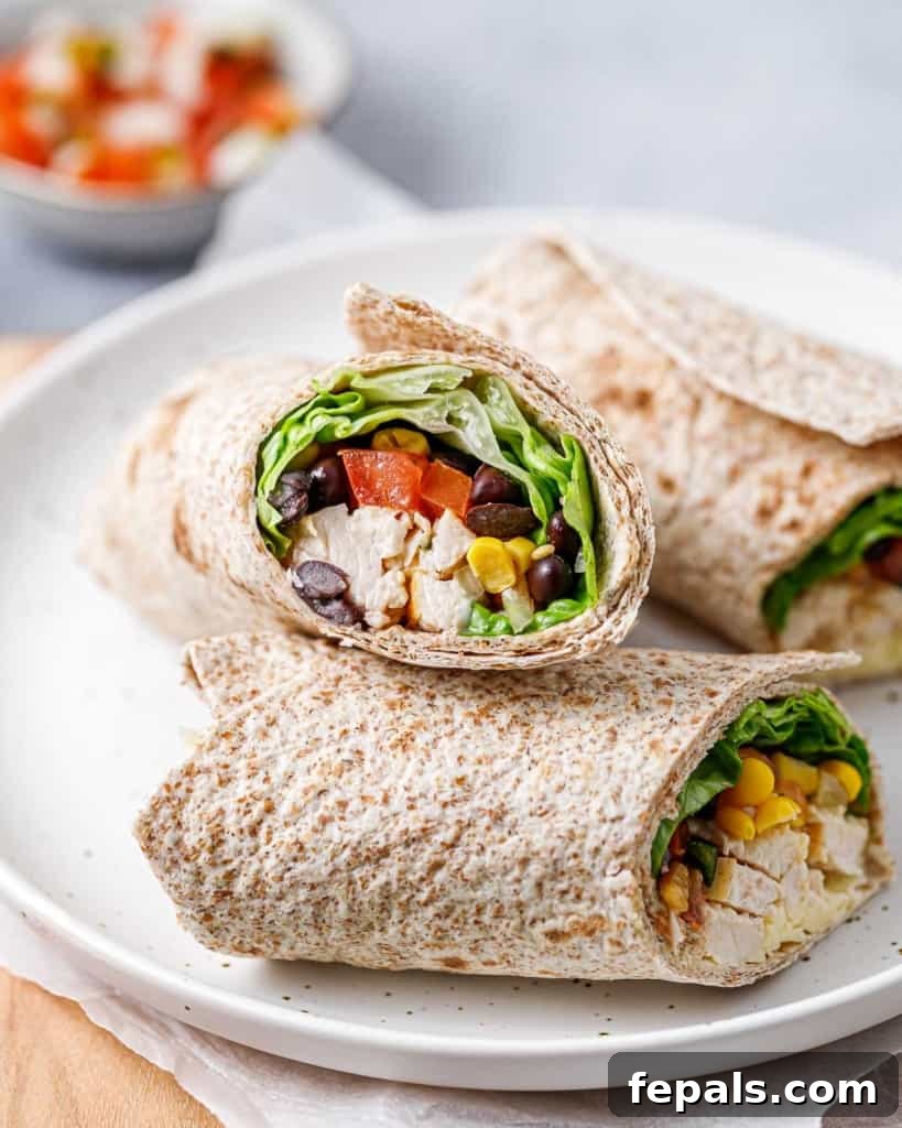 Spicy Southwest Chicken Wrap 12 Three beautifully presented Southwest Chicken Wraps on a white plate, ready to be enjoyed.