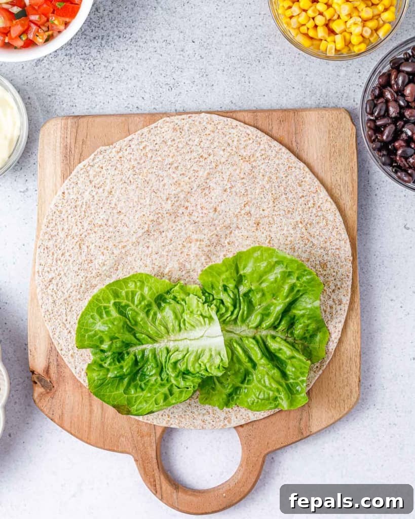 Spicy Southwest Chicken Wrap 6 A fresh, crisp lettuce leaf carefully placed over a soft tortilla wrap, ready for fillings.