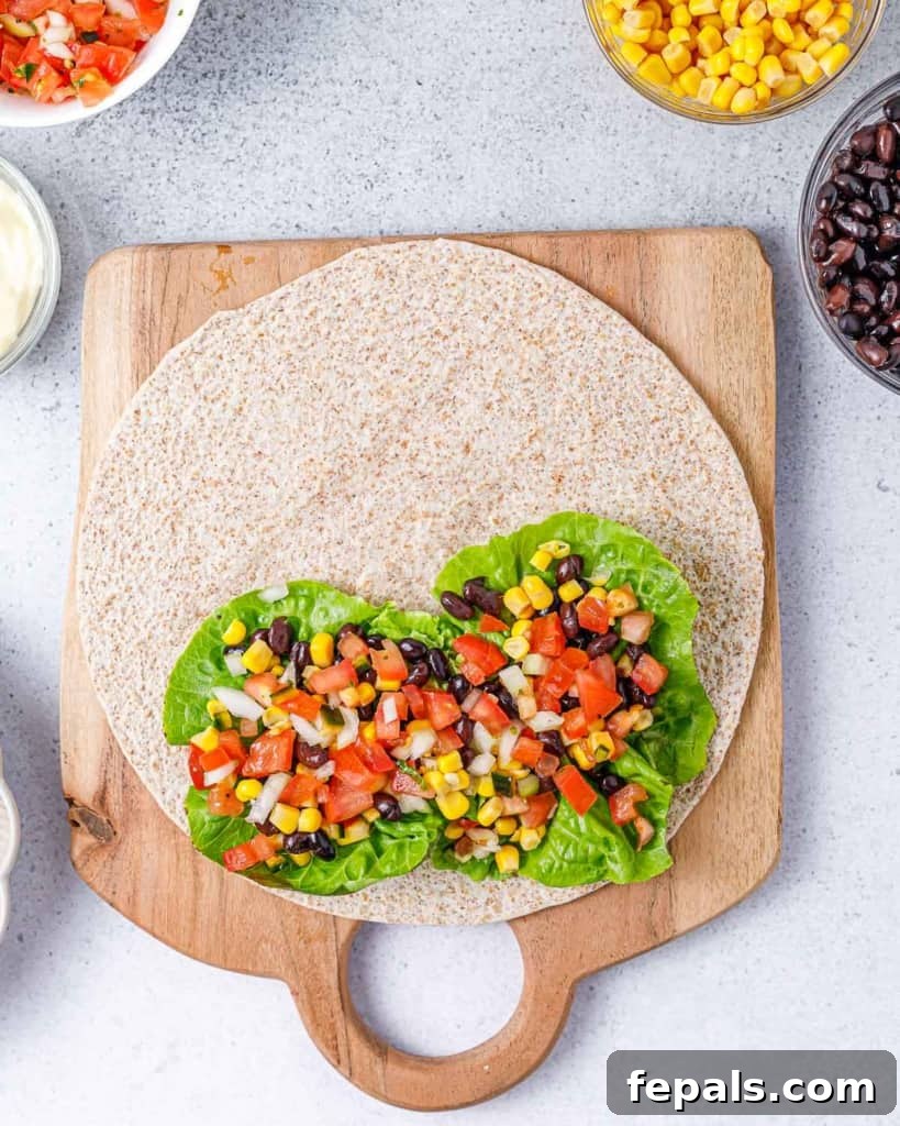 Spicy Southwest Chicken Wrap 9 Fresh pico de gallo layered over the corn, beans, and lettuce, adding a burst of vibrant flavor to the tortilla wrap.