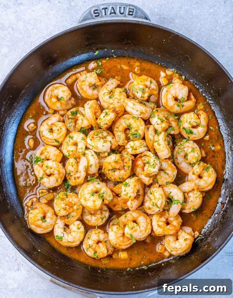 Golden Grits and Gulf Delights 8 Shrimp cooking in a pan.
