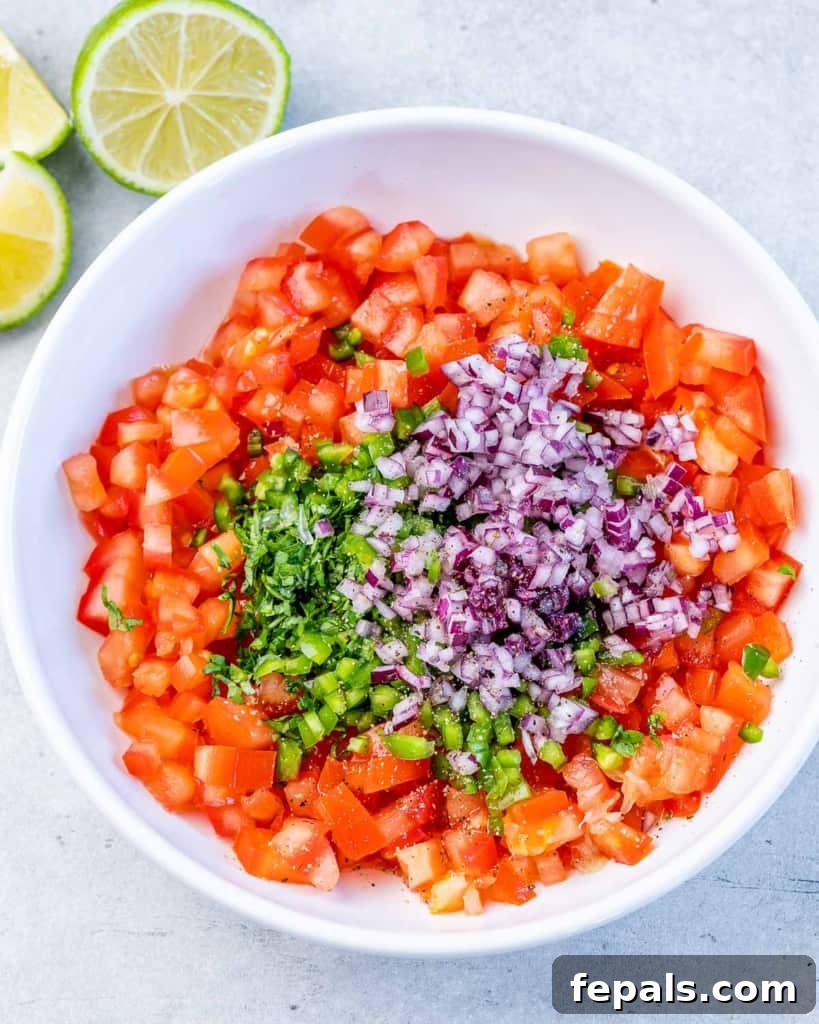 Zesty Salsa Fresca Chicken Bake 6 veggies chopped on a round white plate to make salsa fresca