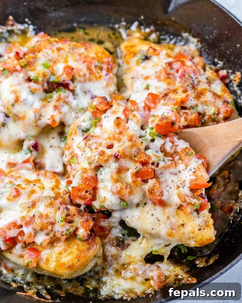 Zesty Salsa Fresca Chicken Bake 10 spatula serving a chicken breast from the pan