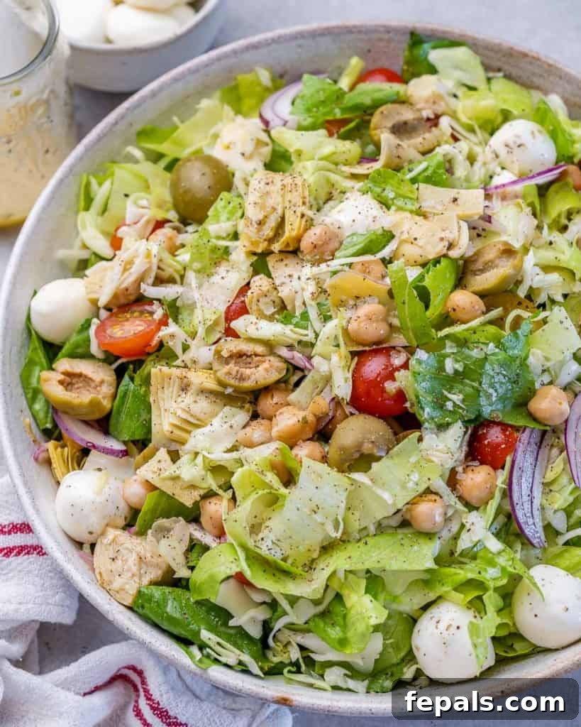 Zesty Italian Chop 3 side shot of chopped salad on a bowl with mozzarella pearls olives, and artichoke, showcasing its rich texture