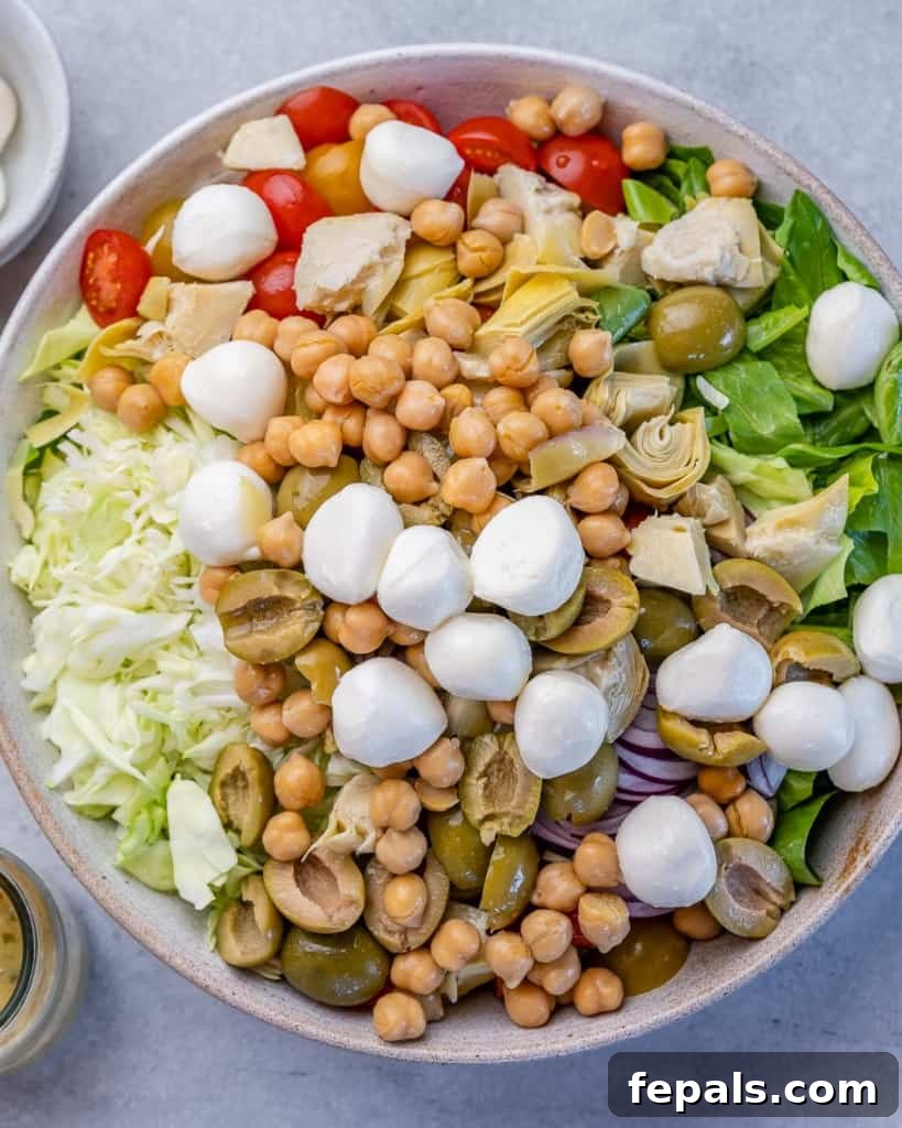 Zesty Italian Chop 6 mozzarella balls, chickpeas, and other veggies added over a salad bowl, layering the flavors