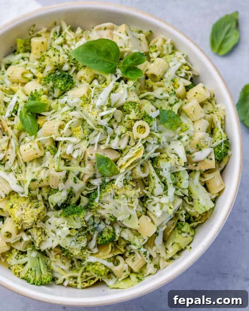 Zesty Green Goddess Pasta Salad 11 Top view of green pasta salad in a round bowl, garnished and ready.
