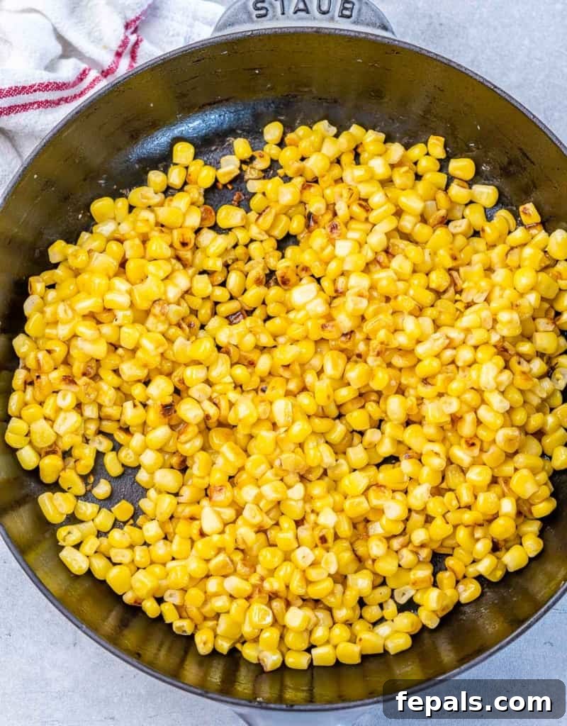 Smoky Chipotle Chicken Rice Bowl 7 Cooking corn in a skillet.