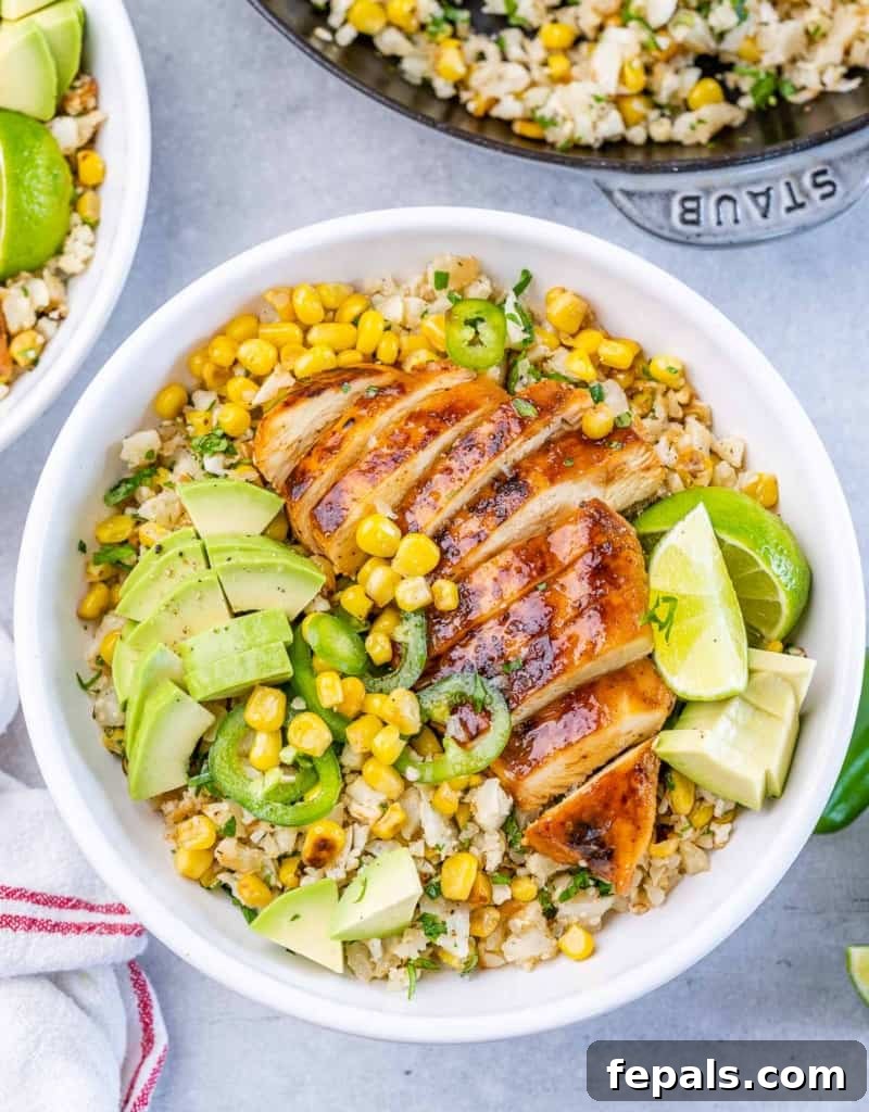 Smoky Chipotle Chicken Rice Bowl 8 Chipotle chicken rice bowl topped with avocado and sliced jalapeños.