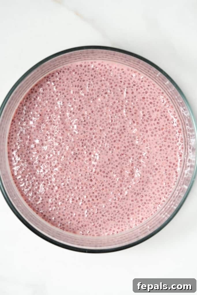 chia seed blended and soaked in raspberry milk in a round bowl, ready for chilling