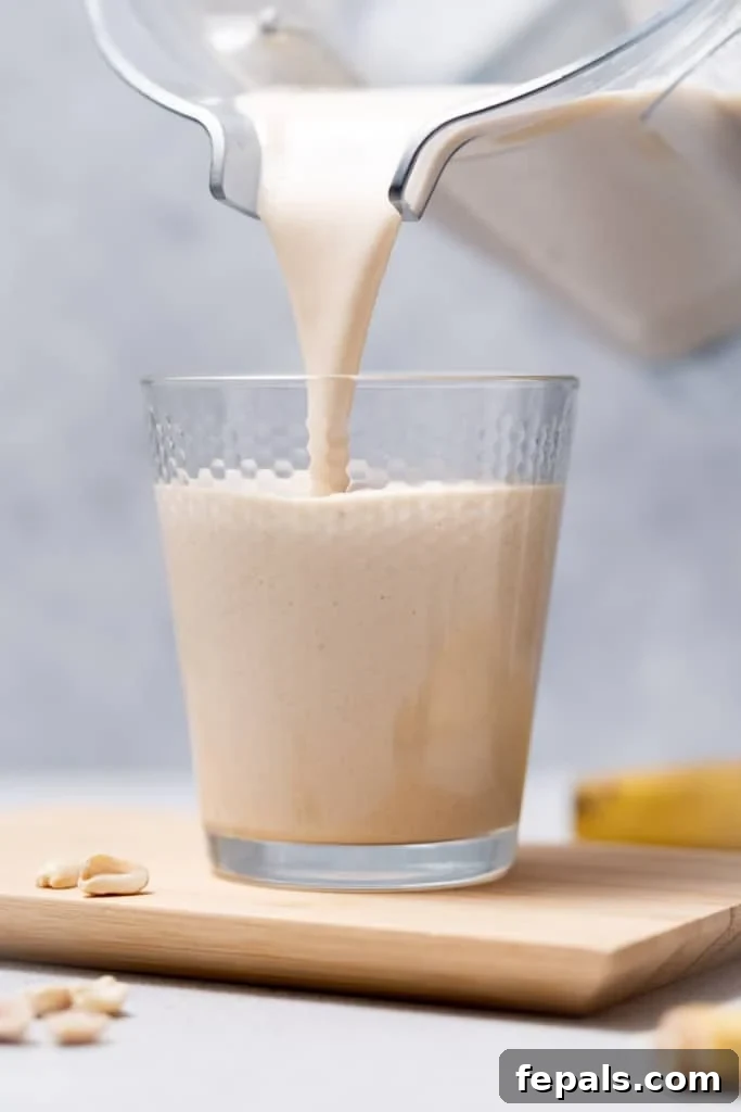 Nutty Banana Bliss Smoothie 8 Pouring a smoothie into a glass.