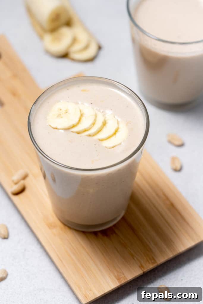 Nutty Banana Bliss Smoothie 10 Adding banana slices over the top of a smoothie.