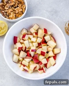 Diced apples in a white bowl.