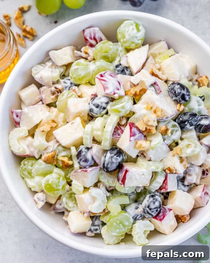 Top view of Waldorf Salad in a round white bowl, beautifully garnished.