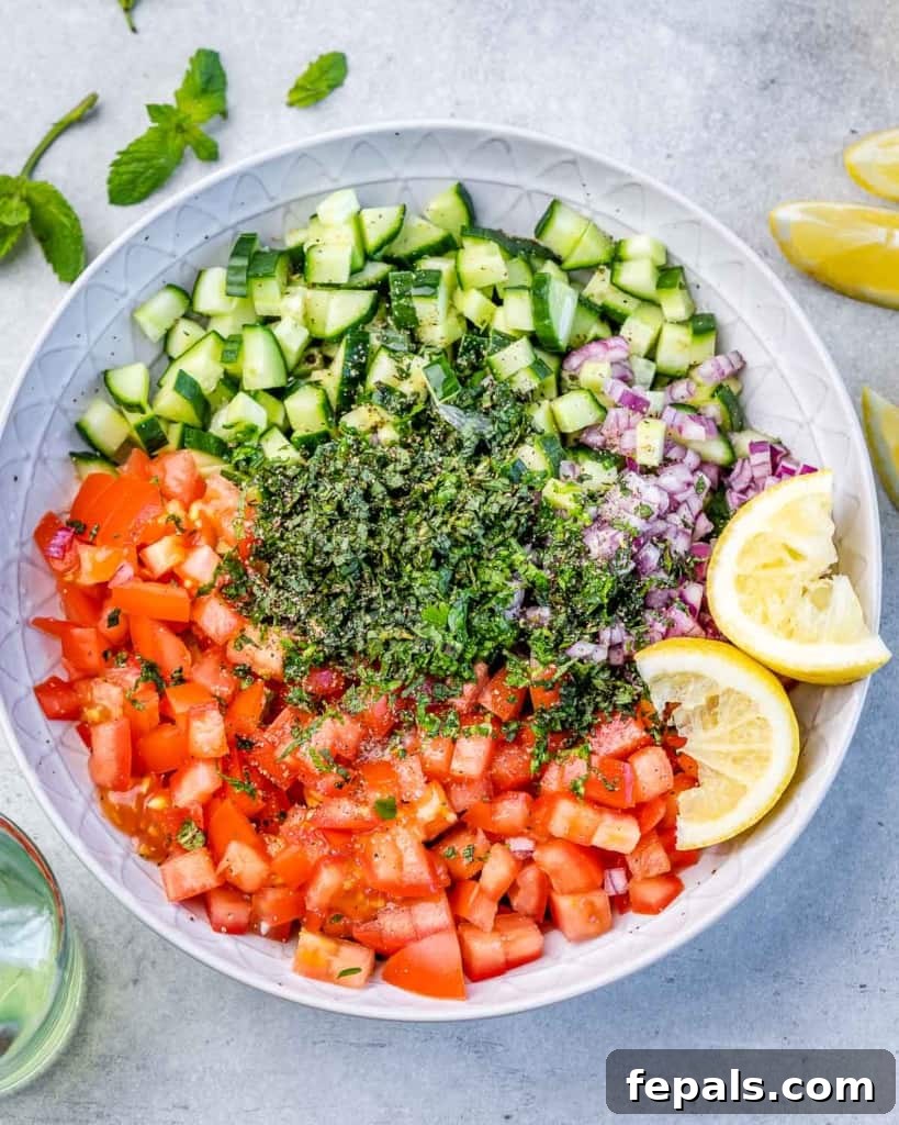 Refreshing Persian Shirazi Salad 6 Chopped cucumber, tomato, red onion, and fresh parsley gathered in a large mixing bowl, ready for the dressing.