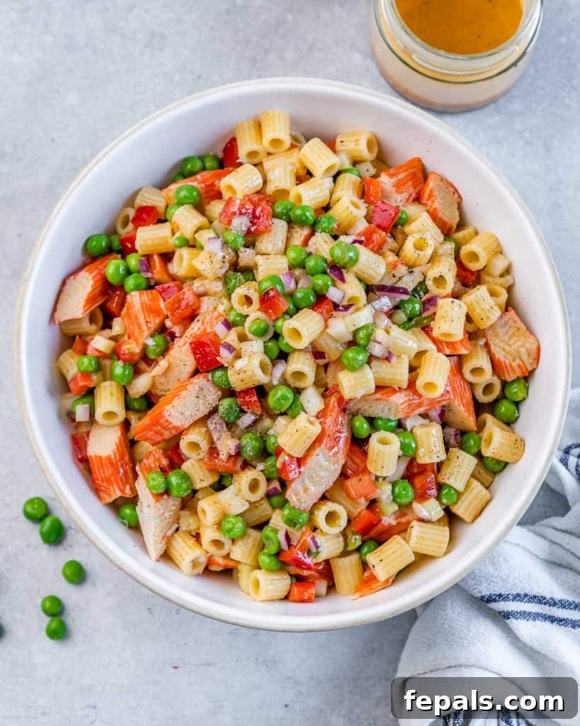 Top view pasta salad with peas and crab.