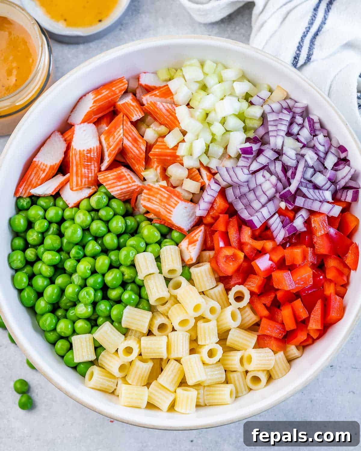 Pasta salad assembled in a white serving bowl.