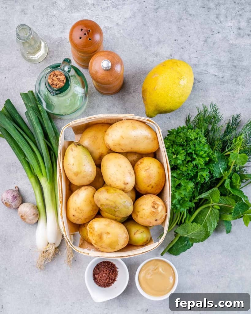A beautiful arrangement of uncooked yellow potatoes, an assortment of fresh herbs, various spices, and a whole lemon, showcasing the fresh ingredients.