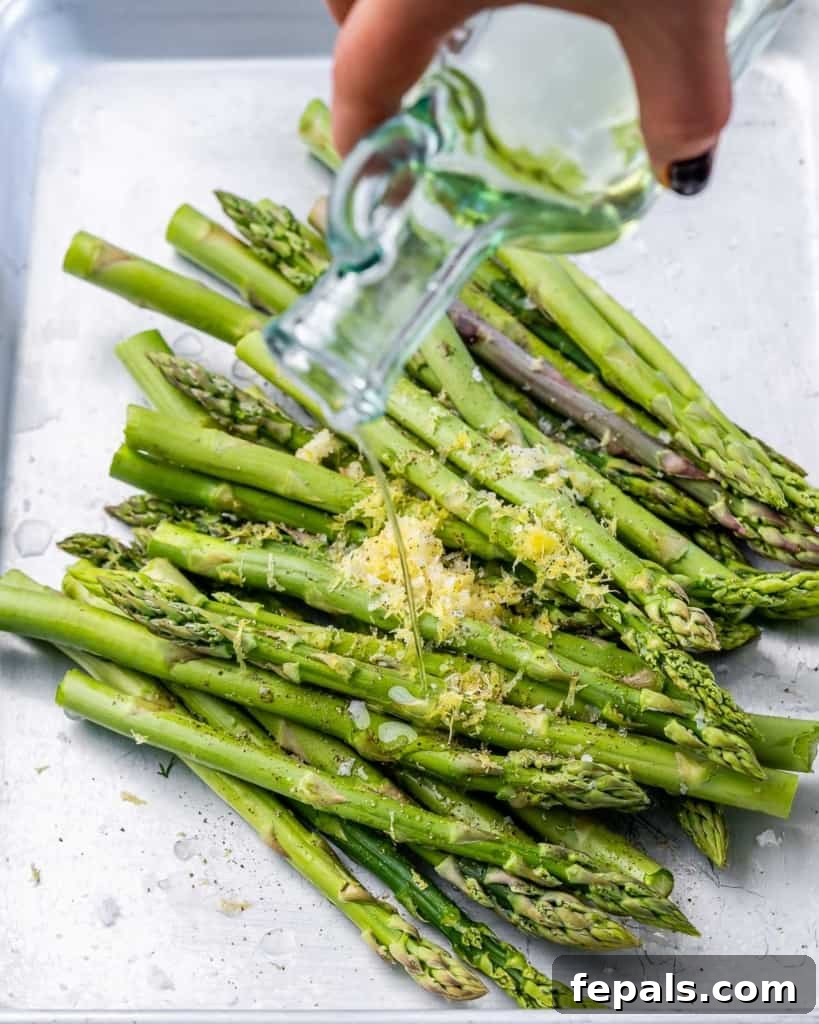 Charred Asparagus with Zesty Lemon-Garlic 6 Drizzling olive oil over spears of asparagus.